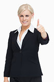 Smiling blond businesswoman thumb-up