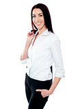 Stylish female executive holding coat over her shoulders