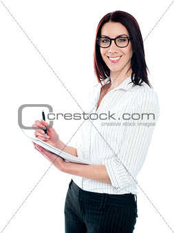 Smiling business woman writing on viral notedpad