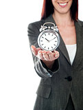 Cropped image of a woman holding alarm clock