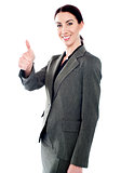 Successful business lady showing thumbs-up