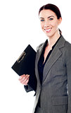 Smiling female secretary holding clipboard