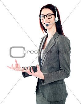 Smiling telemarketing girl posing in headsets