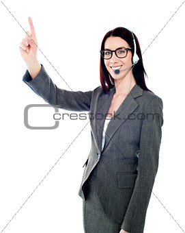 Female executive pointing up at copyspace