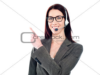 Female operator with headset pointing at something