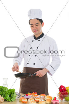  good looking asian chinese chef preparing foods for his custome