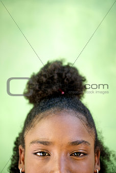 Portrait of happy young african girl looking at camera, smiling