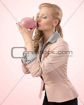 girl kissing her piggybank