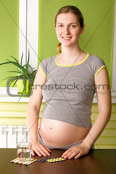 Cute Pregnant Woman On Kitchen