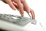 Detail of blurred male hands typing