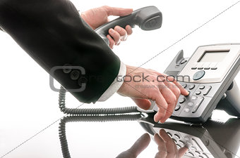 Business man dialing a phone number