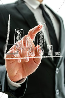 Businessman\'s hand pointing at graph