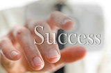 Businessman pointing at success icon on a virtual screen