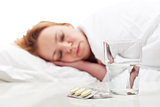 Woman fighting sickness with pills and resting