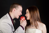 young lovers woman and man biting an apple