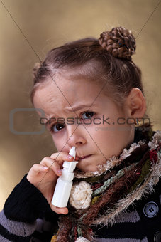 Young girl using nasal spray