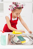 Little girl cleaning the kitchen