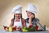 Kids cutting vegetables for a salad