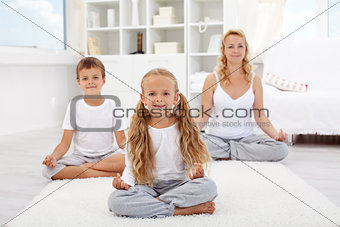 Kids doing yoga relaxing exercise