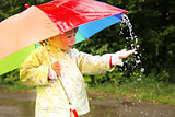 little girl with an umbrella in the rain