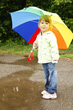 little girl with an umbrella in the rain