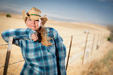 Beautiful Cowgirl Against Wire Fence in Field