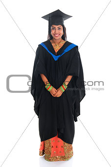 Full body happy Indian university student in graduation gown 