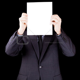 Businessman holding  a sheet of paper in front of his face