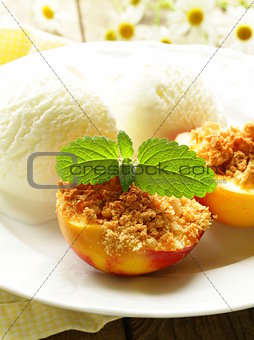 Baked peaches with a scoop of ice cream, summer dessert