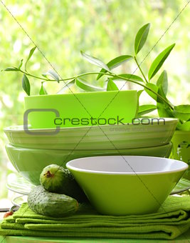 green kitchen utensils on a wooden table