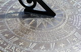 Old detail in bronze sun dial