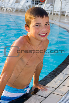 Activities on the pool. Cute boy swimming and playing in water i