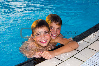 Activities on the pool. Cute boys swimming and playing in water 