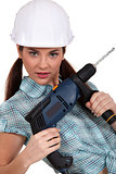 Woman posing with a power drill