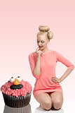 funny portrait of woman with big cupcake