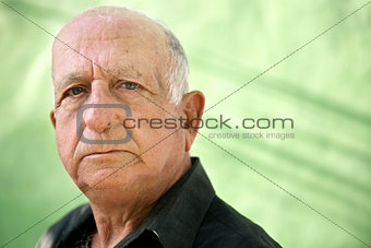 Portrait of serious old hispanic man looking at camera