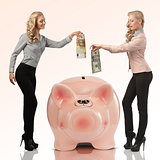 two happy business woman savings her money