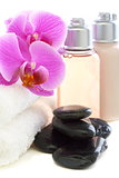 Cosmetics and towels with pink orchid.
