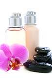 Bottles with cosmetics, stones and orchid