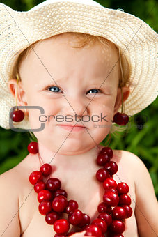 child with cherry beads