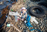 small girl collecting rubbish