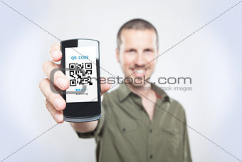 Youn man showing the phone with qr code