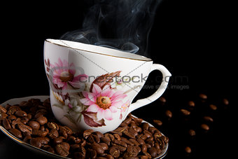 Hot coffee with coffee beans.