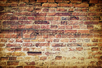 Vintage old weathered brick wall