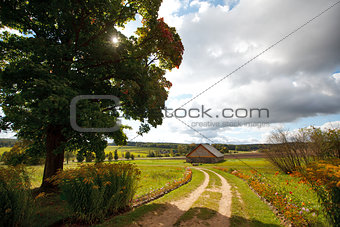 Autumn landscape with a road and house