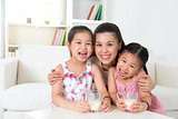Mother and daughters drinking milk 