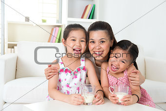 Mother and daughters drinking milk 