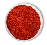 Ground paprika in plate isolated