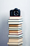 Camera on a high stack of books