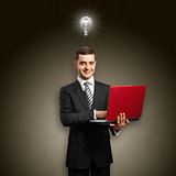 Idea Concept male in suit with laptop in his hands
